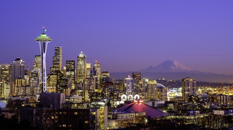 Skyline notturno di Seattle con Mount Rainier in lontananza